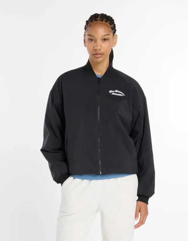 New Balance Women's Linear Heritage Woven Bomber Jacket in Black Nylon Woven